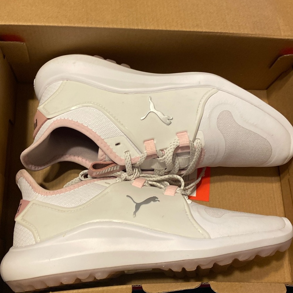 Pink and white puma golf shoes